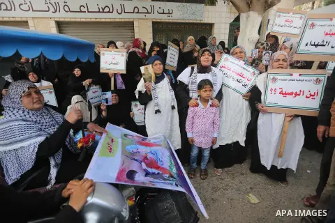 Palestinian families of martyrs, hold banners during a protest to demand their salaries, in Gaza city, on May 10, 2016. Photo by Mohammed Asad