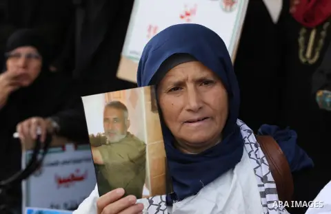 Palestinian families of martyrs, hold banners during a protest to demand their salaries, in Gaza city, on May 10, 2016. Photo by Mohammed Asad
