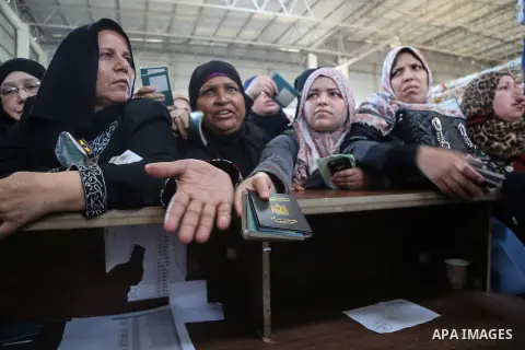 Palestinians wait for travel permits to cross into Egypt through the Rafah border crossing after it was opened for two days by Egyptian authorities, in the southern Gaza Strip May 11, 2016. Photo by Mohammed Dahman