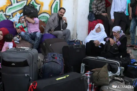 Palestinians wait at the Rafah border crossing with Egypt, in the southern Gaza Strip, after it was opened for two days by Egyptian authorities on May 12, 2016. Israeli Defence Minister Moshe Yaalon announced on May 2, 2...