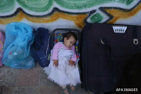 Palestinians wait at the Rafah border crossing with Egypt, in the southern Gaza Strip, after it was opened for two days by Egyptian authorities on May 12, 2016. Israeli Defence Minister Moshe Yaalon announced on May 2, 2...