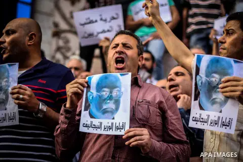 Egyptian Journalists and activists chant slogans and hold banners during a protest in front of the Journalists' Syndicate in Cairo, Egypt, on May 12, 2016. Egypt's journalists' syndicate called for the dismissal of the i...