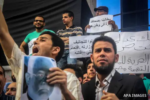Egyptian Journalists and activists chant slogans and hold banners during a protest in front of the Journalists' Syndicate in Cairo, Egypt, on May 12, 2016. Egypt's journalists' syndicate called for the dismissal of the i...