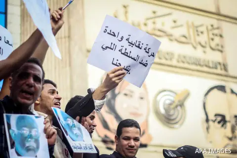 Egyptian Journalists and activists chant slogans and hold banners during a protest in front of the Journalists' Syndicate in Cairo, Egypt, on May 12, 2016. Egypt's journalists' syndicate called for the dismissal of the i...