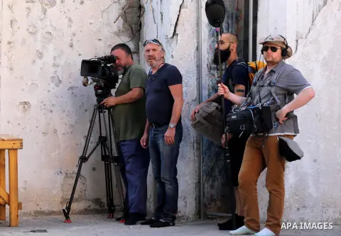 Chinese artist Ai Weiwei and his film crew work on a documentary film on refugees, in Nuseirat refugee camp in the central Gaza Strip on May 12, 2016. Photo by Mohammed Asad