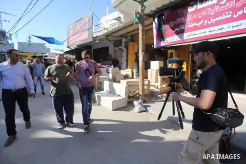 Chinese artist Ai Weiwei and his film crew work on a documentary film on refugees, in Nuseirat refugee camp in the central Gaza Strip on May 12, 2016. Photo by Mohammed Asad