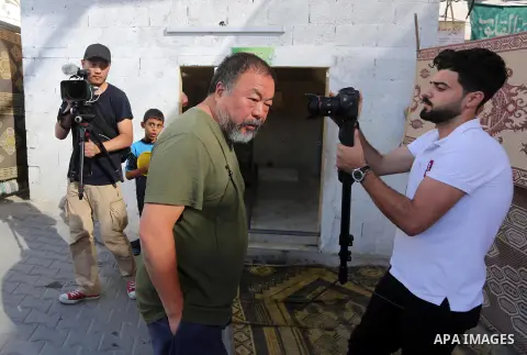 Chinese artist Ai Weiwei and his film crew work on a documentary film on refugees, in Nuseirat refugee camp in the central Gaza Strip on May 12, 2016. Photo by Mohammed Asad