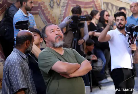 Chinese artist Ai Weiwei looks on as he works on a documentary film on refugees, in Nuseirat refugee camp in the central Gaza Strip on May 12, 2016. Photo by Mohammed Asad