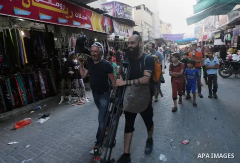 Chinese artist Ai Weiwei and his film crew work on a documentary film on refugees, in Nuseirat refugee camp in the central Gaza Strip on May 12, 2016. Photo by Mohammed Asad