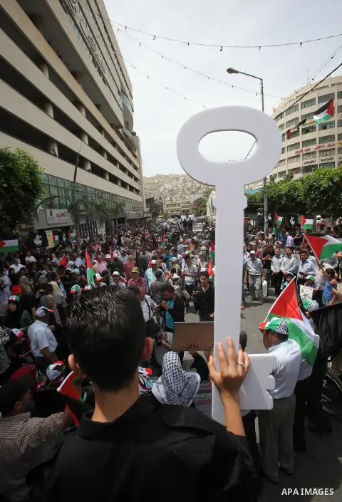 Palestinians wave national flags on May 15, 2016 in the West Bank city of Nablus during a rally to commemorate the "Nakba" or "catastrophe" in Arabic in reference to the establishment in 1948 of the state of Israel. "Nak...
