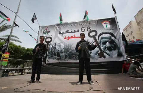 Palestinians wave national flags on May 15, 2016 in the West Bank city of Nablus during a rally to commemorate the "Nakba" or "catastrophe" in Arabic in reference to the establishment in 1948 of the state of Israel. "Nak...