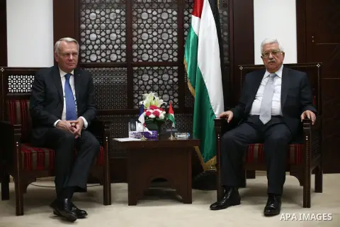 Palestinian Foreign Minister Riyad al-Maliki waves to media as French Foreign Minister Jean-Marc Ayrault (R) arrives to meet Palestinian President Mahmoud Abbas in the West Bank city of Ramallah May 15, 2016. apaimages/F...