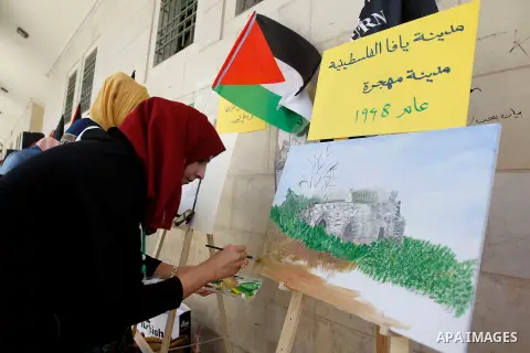 Palestinian artists paint artwork during a rally marking the 68th anniversary of the Nakba in the West Bank city of Hebron May 15, 2016. "Nakba" means in Arabic "catastrophe" in reference to the birth of the state of Isr...