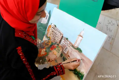 Palestinian artists paint artwork during a rally marking the 68th anniversary of the Nakba in the West Bank city of Hebron May 15, 2016. "Nakba" means in Arabic "catastrophe" in reference to the birth of the state of Isr...