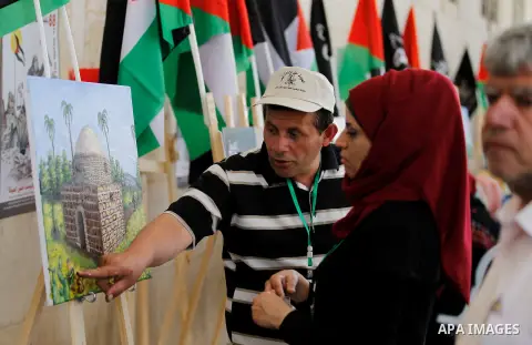Palestinian artists paint artwork during a rally marking the 68th anniversary of the Nakba in the West Bank city of Hebron May 15, 2016. "Nakba" means in Arabic "catastrophe" in reference to the birth of the state of Isr...