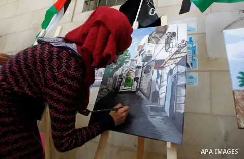 Palestinian artists paint artwork during a rally marking the 68th anniversary of the Nakba in the West Bank city of Hebron May 15, 2016. "Nakba" means in Arabic "catastrophe" in reference to the birth of the state of Isr...