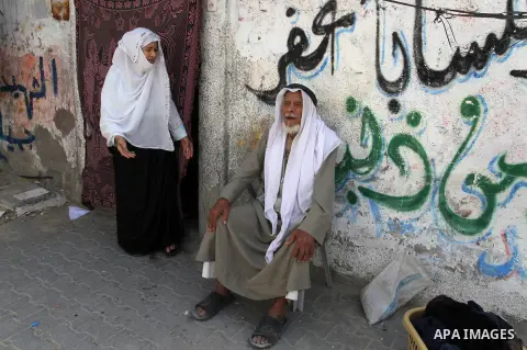 A Palestinian man and his wife sit in front of their house on the 68th anniversary of the "Nakba" in the southern Gaza Strip town of Khan Younis on May 15, 2016. "Nakba" means in Arabic "catastrophe" in reference to the...