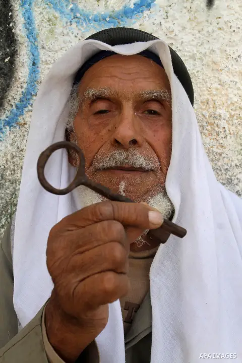A palestinian man holds key symbolising the homes they left in 1948 in front of his house in the southern Gaza Strip town of Khan Younis on May 15, 2016. "Nakba" means in Arabic "catastrophe" in reference to the birth of...