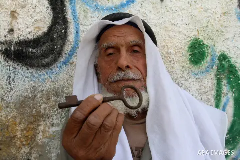 A palestinian man holds key symbolising the homes they left in 1948 in front of his house in the southern Gaza Strip town of Khan Younis on May 15, 2016. "Nakba" means in Arabic "catastrophe" in reference to the birth of...
