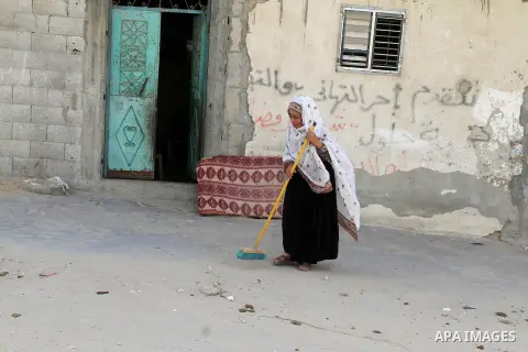 A Palestinian woman cleans outside her house on the 68th anniversary of the "Nakba" in the southern Gaza Strip town of Khan Younis on May 15, 2016. "Nakba" means in Arabic "catastrophe" in reference to the birth of the s...