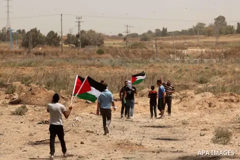 Palestinians take part during a rally to commemorate the "Nakba" or "catastrophe" in Arabic in reference to the establishment in 1948 of the state of Israel near the Nahal Oz crossing east of Gaza City on May 15, 2016. "...