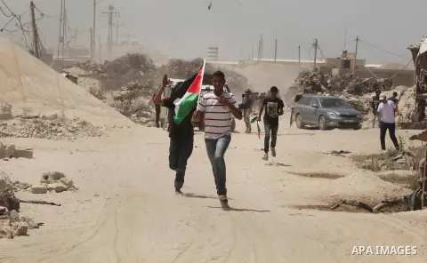 Palestinians take part during a rally to commemorate the "Nakba" or "catastrophe" in Arabic in reference to the establishment in 1948 of the state of Israel near the Nahal Oz crossing east of Gaza City on May 15, 2016. "...