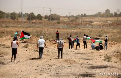 Palestinians take part during a rally to commemorate the "Nakba" or "catastrophe" in Arabic in reference to the establishment in 1948 of the state of Israel near the Nahal Oz crossing east of Gaza City on May 15, 2016. "...