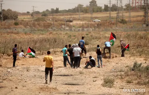 Palestinians take part during a rally to commemorate the "Nakba" or "catastrophe" in Arabic in reference to the establishment in 1948 of the state of Israel near the Nahal Oz crossing east of Gaza City on May 15, 2016. "...