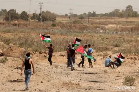 Palestinians take part during a rally to commemorate the "Nakba" or "catastrophe" in Arabic in reference to the establishment in 1948 of the state of Israel near the Nahal Oz crossing east of Gaza City on May 15, 2016. "...
