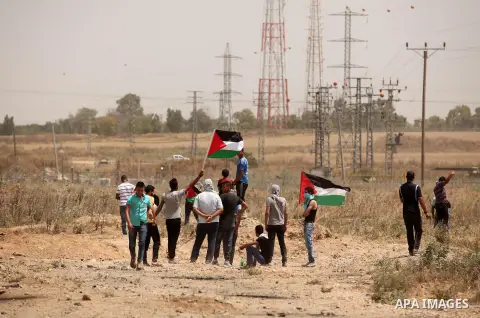 Palestinians take part during a rally to commemorate the "Nakba" or "catastrophe" in Arabic in reference to the establishment in 1948 of the state of Israel near the Nahal Oz crossing east of Gaza City on May 15, 2016. "...