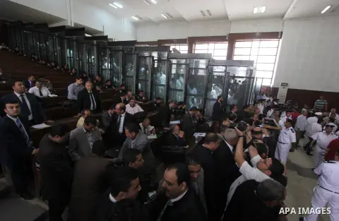 Egyptian Muslim Brotherhood members stand inside the defendants cage during their trial in the capital Cairo on May 17, 2016. Photo by Amr Sayed