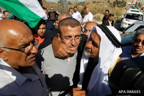 Palestinian imprisoned journalist, Mohammed al-Qiq hugs arrives in his village Dura, in southern West Bank after he was released from the Israeli Nafha Prison on May 19, 2016. Mohammed al-Qiq, 33, held by Israel without...
