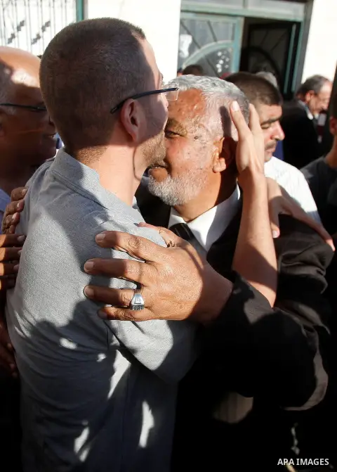 Palestinian imprisoned journalist, Mohammed al-Qiq hugs his father as he arrives in his village Dura, in southern West Bank after he was released from the Israeli Nafha Prison on May 19, 2016. Mohammed al-Qiq, 33, held b...