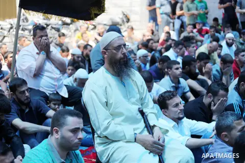 Palestinian supporters of the Islamic Jihad Movement attend Friday prayers to show solidarity with Palestinian prisoners in Israeli Jails, in front of Red cross office in Gaza city, on May 20, 2016. Photo by Mohammed Asa...