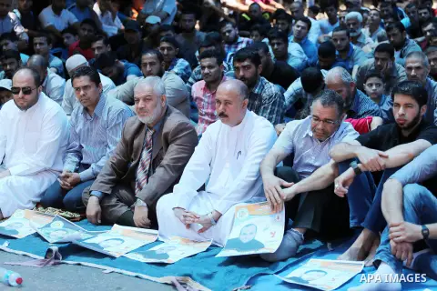 Palestinian supporters of the Islamic Jihad Movement attend Friday prayers to show solidarity with Palestinian prisoners in Israeli Jails, in front of Red cross office in Gaza city, on May 20, 2016. Photo by Mohammed Asa...