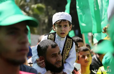 Palestinian supporters of the Islamist movement Hamas take part during a rally to commemorate the 68th anniversary of the "Nakba" or "catastrophe" in Arabic in reference to the establishment in 1948 of the state of Israe...