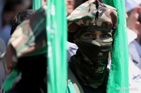 Palestinian supporters of the Islamist movement Hamas take part during a rally to commemorate the 68th anniversary of the "Nakba" or "catastrophe" in Arabic in reference to the establishment in 1948 of the state of Israe...