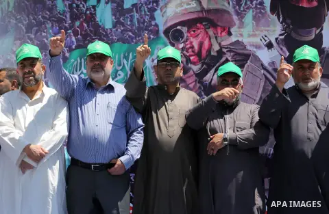 Palestinian supporters of the Islamist movement Hamas take part during a rally to commemorate the 68th anniversary of the "Nakba" or "catastrophe" in Arabic in reference to the establishment in 1948 of the state of Israe...