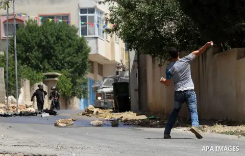 A Palestinian protester hurls stones towards Israeli security forces during clashes following a demonstration against the expropriation of Palestinian land by Israel, on May 20, 2016 in the village of Kfar Qaddum, near N...