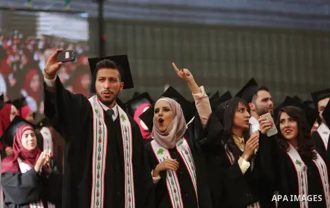 Palestinian students attend their graduation ceremony at the end of the academic year on May 21, 2016 at Birzeit University in the West Bank town of Birzeit, near Ramallah. Photo by Shadi Hatem