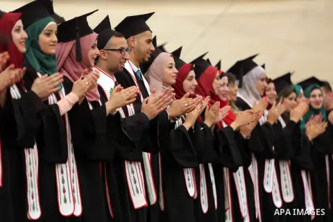 Palestinian students attend their graduation ceremony at the end of the academic year on May 21, 2016 at Birzeit University in the West Bank town of Birzeit, near Ramallah. Photo by Shadi Hatem