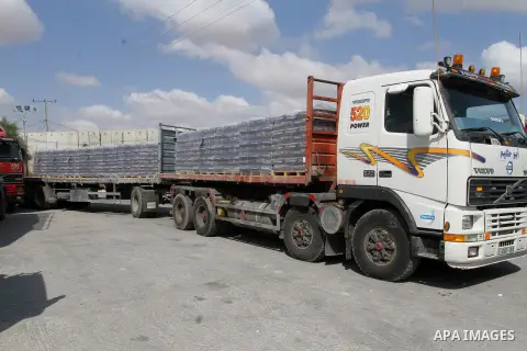 Loaded trucks cross the Kerem Shalom crossing to Rafah in southern Gaza Strip on May 23, 2016. Israel said on May 22 it was lifting a ban imposed last month on private imports of cement to the Hamas-run Gaza Strip. The b...
