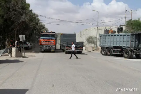 Loaded trucks cross the Kerem Shalom crossing to Rafah in southern Gaza Strip on May 23, 2016. Israel said on May 22 it was lifting a ban imposed last month on private imports of cement to the Hamas-run Gaza Strip. The b...