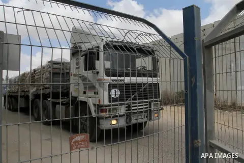 Loaded trucks cross the Kerem Shalom crossing to Rafah in southern Gaza Strip on May 23, 2016. Israel said on May 22 it was lifting a ban imposed last month on private imports of cement to the Hamas-run Gaza Strip. The b...