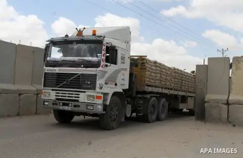 Loaded trucks cross the Kerem Shalom crossing to Rafah in southern Gaza Strip on May 23, 2016. Israel said on May 22 it was lifting a ban imposed last month on private imports of cement to the Hamas-run Gaza Strip. The b...