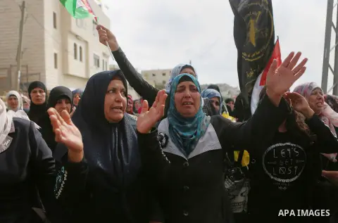 Relatives of Palestinian woman Maram Abu Ismail and her brother Ibrahim Taha, who were shot dead by Israeli police last month, mourn during their funeral near the West Bank city of Ramallah May 23, 2016. Photo by Shadi H...