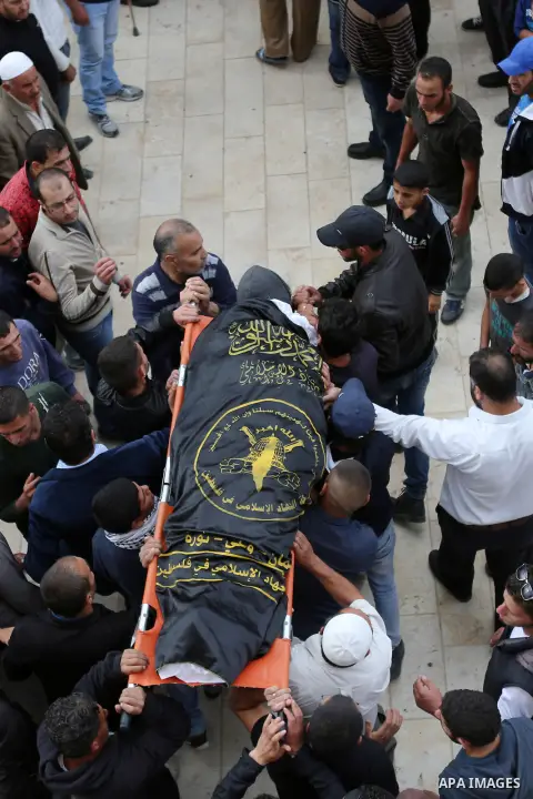 Mourners carry the body of Palestinian woman Maram Abu Ismail, who was shot dead by Israeli police along with her brother last month, during their funeral near the West Bank city of Ramallah May 23, 2016. Photo by Shadi...