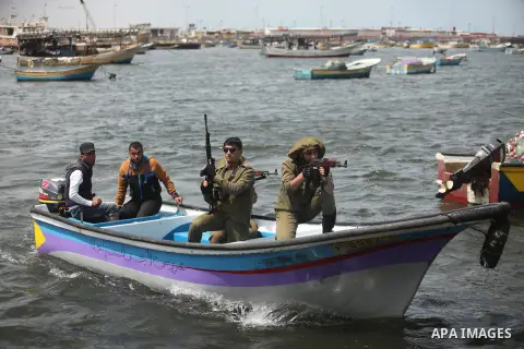 Palestinians take part in a protest against the Israeli blockade of the Gaza Strip at the Gaza seaport, on May 24, 2016. Photo by Ashraf Amra