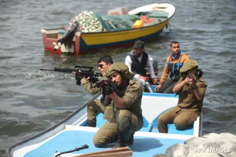 Palestinians take part in a protest against the Israeli blockade of the Gaza Strip at the Gaza seaport, on May 24, 2016. Photo by Ashraf Amra