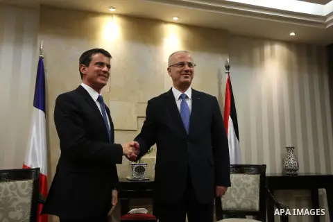 French Prime Minister Manuel Valls and Palestinian prime minister Rami Hamdallah shake hands during a meeting in the West Bank city of Ramallah, on May 24, 2016. Palestinian prime minister Rami Hamdallah dismissed an Isr...
